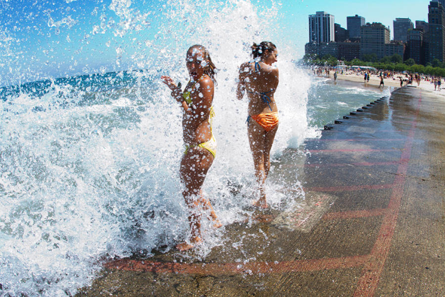 Two girls play in the waves at North Avenue Beach